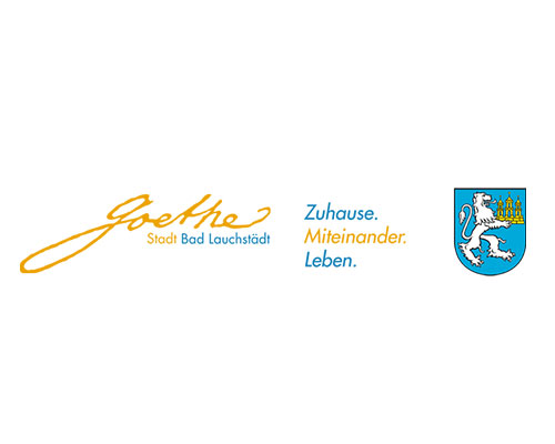 Logo for Bad Lauchstädt: orange Goethe signature, blue motto 'Zuhause. Miteinander. Leben.', and the town crest on the right.